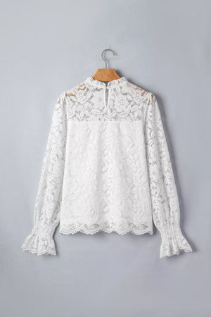 White lace blouse with ruffled neckline and cuffs, long sleeves