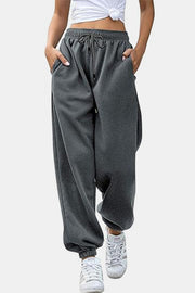 Relaxed-fit gray sweatpants with drawstring waist and cuffed ankles.