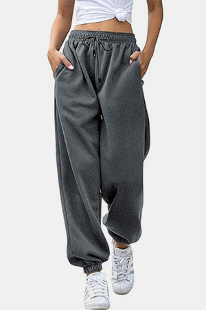Relaxed-fit gray sweatpants with drawstring waist and cuffed ankles.