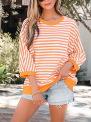 Oversized orange and white striped cotton t-shirt with 3/4 sleeves and crew neck.