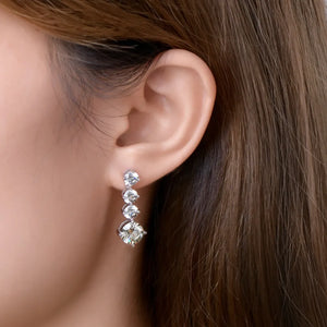 Silver cascade cubic zirconia drop earrings with four graduated stones.