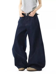 Oversized dark wash denim jeans with wide legs and pockets.