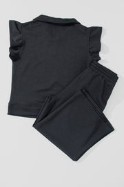 Black textured loungewear set with ruffle sleeve zip-up top and drawstring pants.