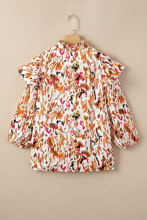Blouse with abstract print, ruffled aura sleeves, and mock neck.
