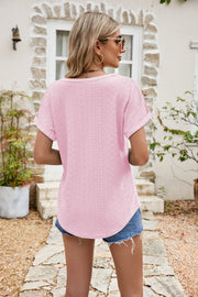Perforated sleeve tee in blush pink with rolled cuffs and a textured pattern.