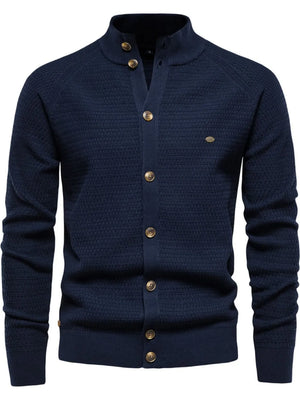 Navy textured knit stand collar cardigan with button closure and subtle chest detail.