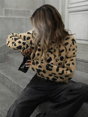 Fuzzy knit leopard print sweater with crew neck and long sleeves.