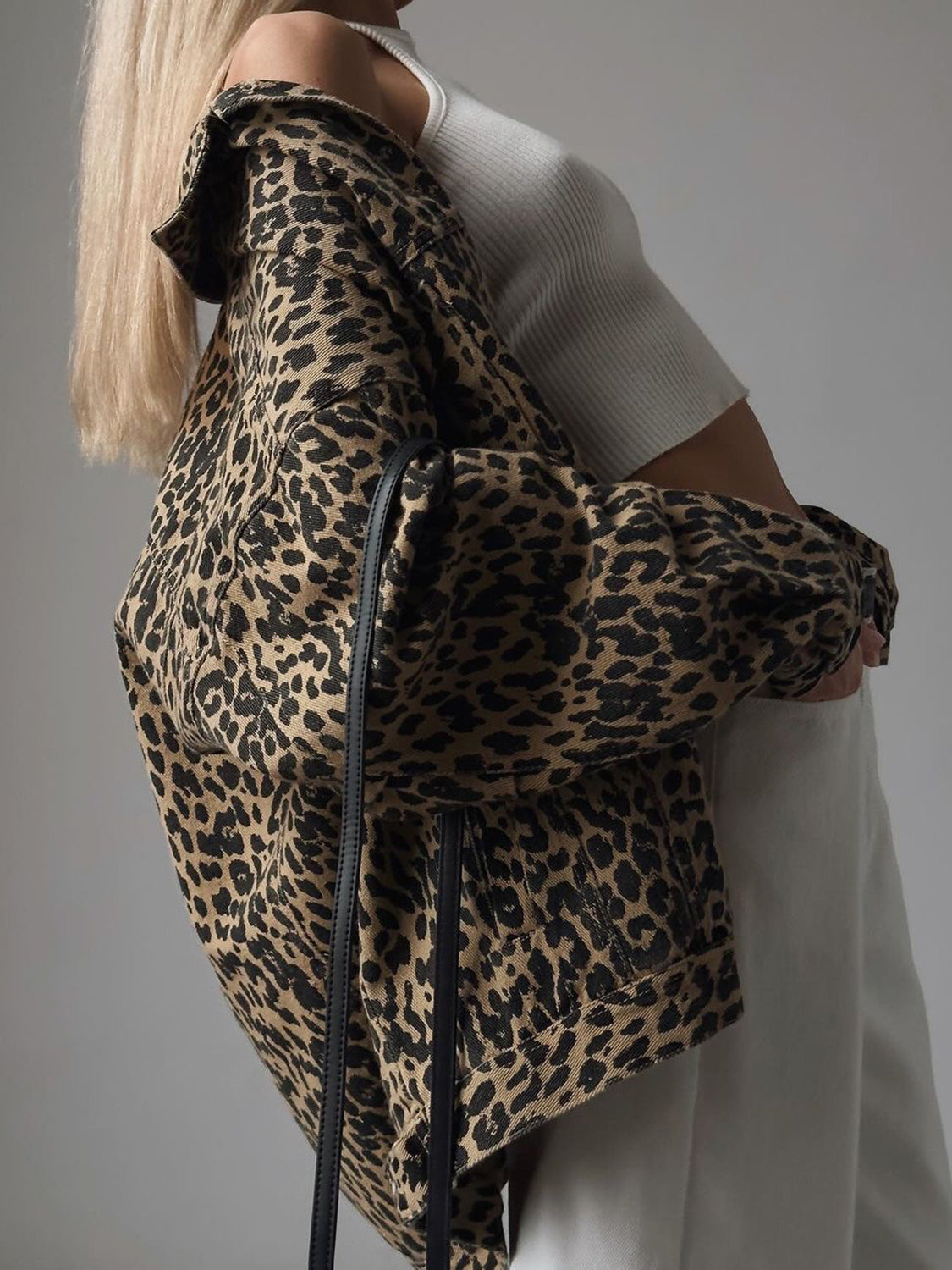 Oversized leopard print denim jacket with button details and a collar.