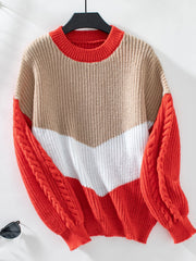 Chevron colorblock cable knit sweater in tan, white, and orange-red with cable sleeves.