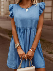 Light blue denim babydoll dress with ruffled sleeves and tiered skirt.