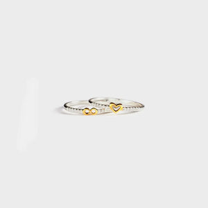 Silver rings with gold heart and infinity symbols, set with small stones