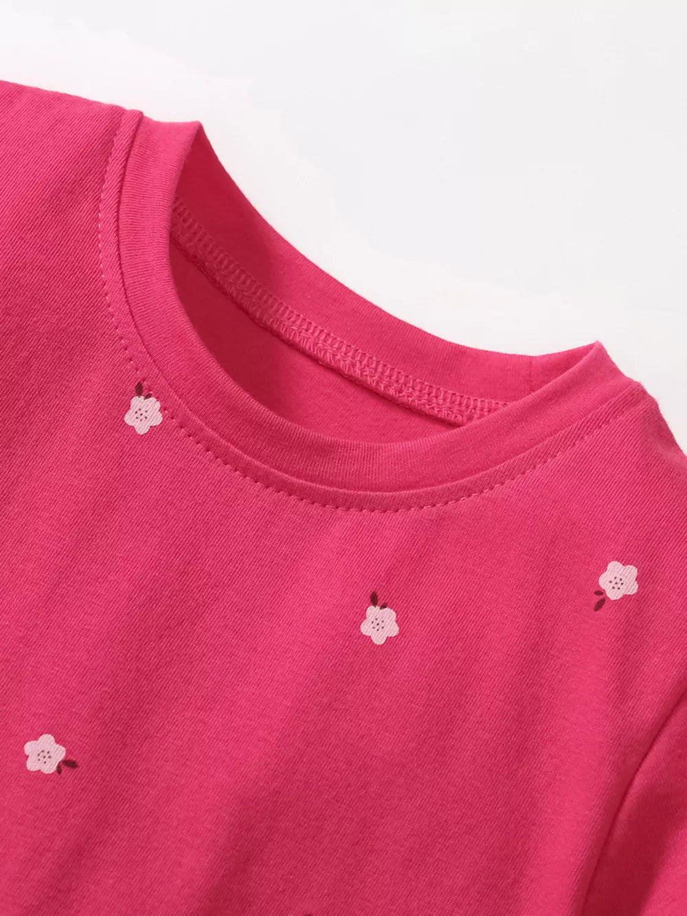 Pink cotton toddler dress with embroidered flowers and round neckline.