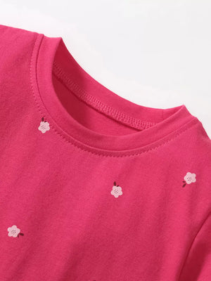 Pink cotton toddler dress with embroidered flowers and round neckline.