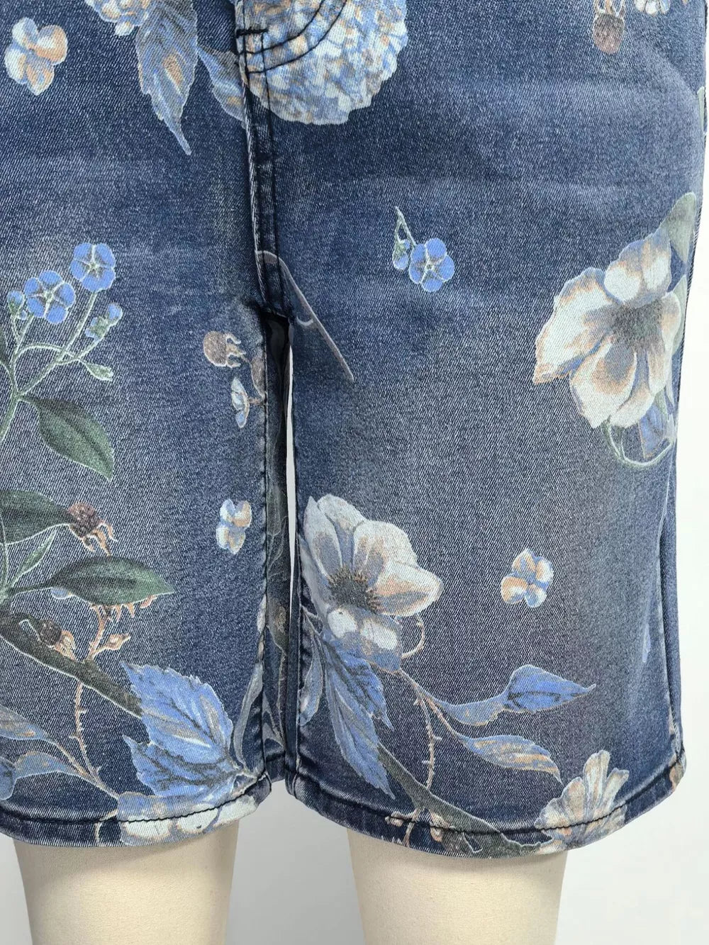 Blue denim shorts with a botanical print and relaxed fit.