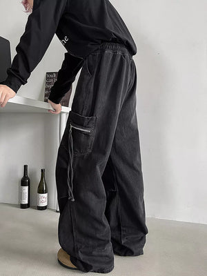 Black relaxed fit cotton cargo jeans with drawstring waist and zippered pocket detail.
