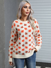 Cream knit crewneck sweater with an autumnal leaf motif in orange and brown.