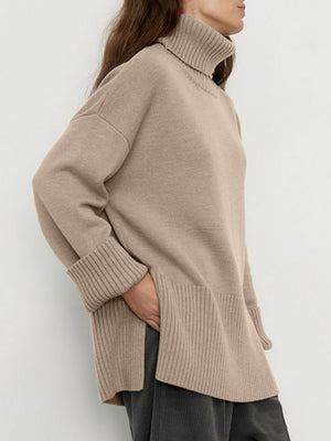 Khaki ribbed turtleneck sweater with flared sleeves and cuffed hem.