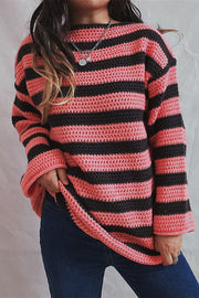 Pink and black striped boat neck knit sweater with open knit texture.