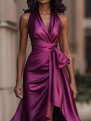 Purple satin high-low ruffled maxi dress with halter neck and cinched waist tie.