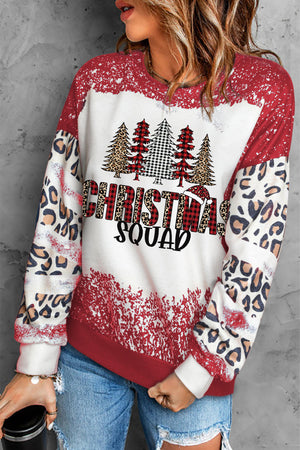 Christmas Squad graphic sweatshirt in brick red with leopard print sleeves and distressed detail.