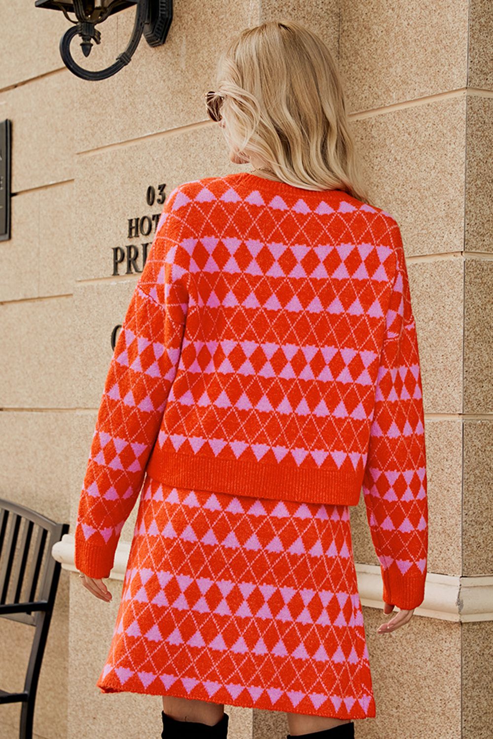 Orange argyle knit cardigan and mini skirt set with pink diamond pattern.