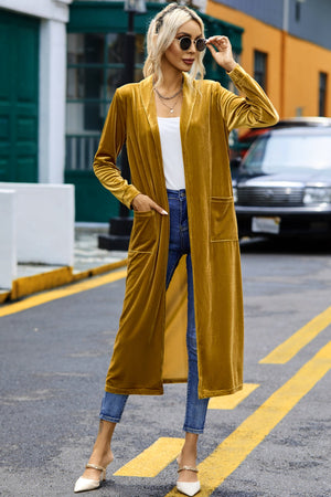 Mustard velvet duster with pockets, open front, long sleeves, and a long cut.