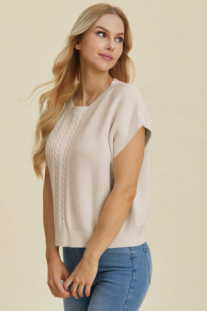 Beige cable knit cap sleeve pullover sweater with crew neck.