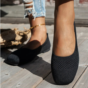 Black breathable knit square-toe flats with a textured pattern on the vamp.