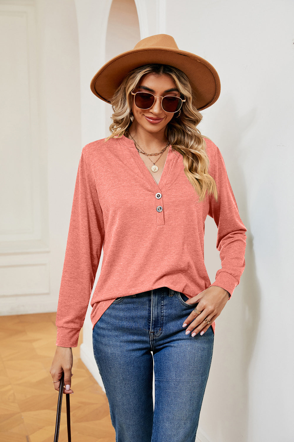 Coral henley-inspired long sleeve top with button detail and v-neck