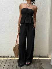 Black pleated tube top with tie detail and matching wide-leg pants with pockets.