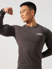 Dark gray performance raglan sleeve tee with white LION logo on chest.