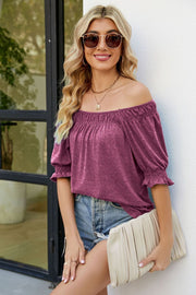 Gathered off-the-shoulder plum blouse with puff sleeves and ruffled cuffs.