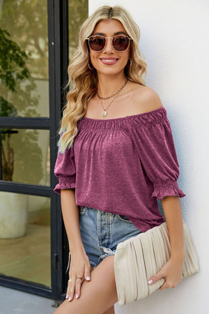 Gathered off-the-shoulder plum blouse with puff sleeves and ruffled cuffs.
