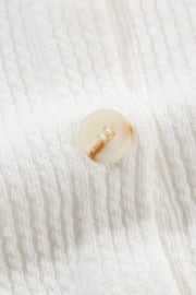 White textured corduroy overshirt with a marbled button detail.