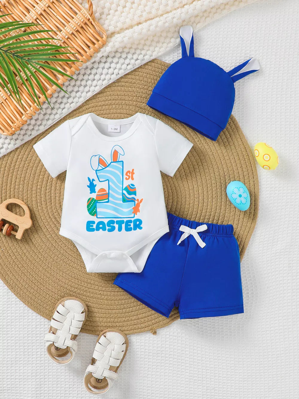 Baby Easter outfit with white 1st Easter graphic bodysuit and blue shorts.