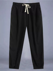 Black relaxed fit drawstring sweatpants with ankle cuffs and pockets.