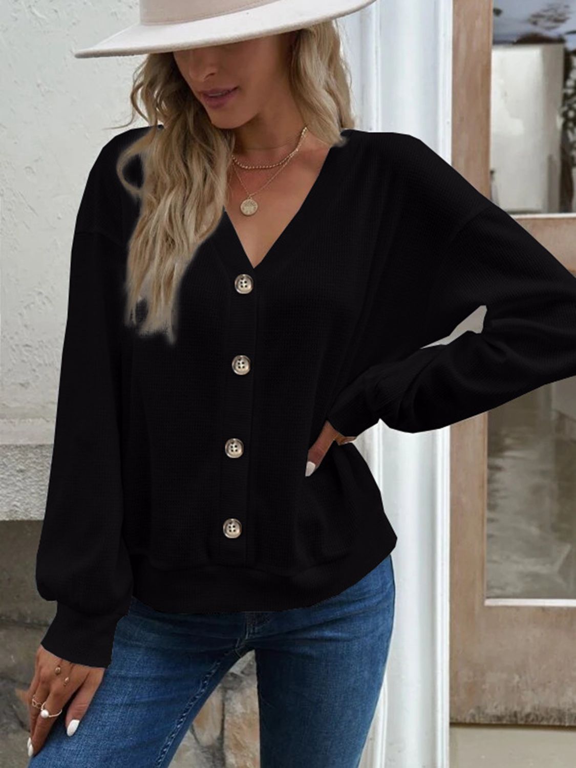 Black waffle knit button-down cardigan with V-neck and gold buttons