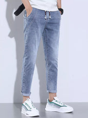 Light blue washed skinny jeans with adjustable drawstring and cuffed ankles.
