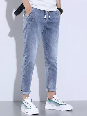 Light blue washed skinny jeans with adjustable drawstring and cuffed ankles.