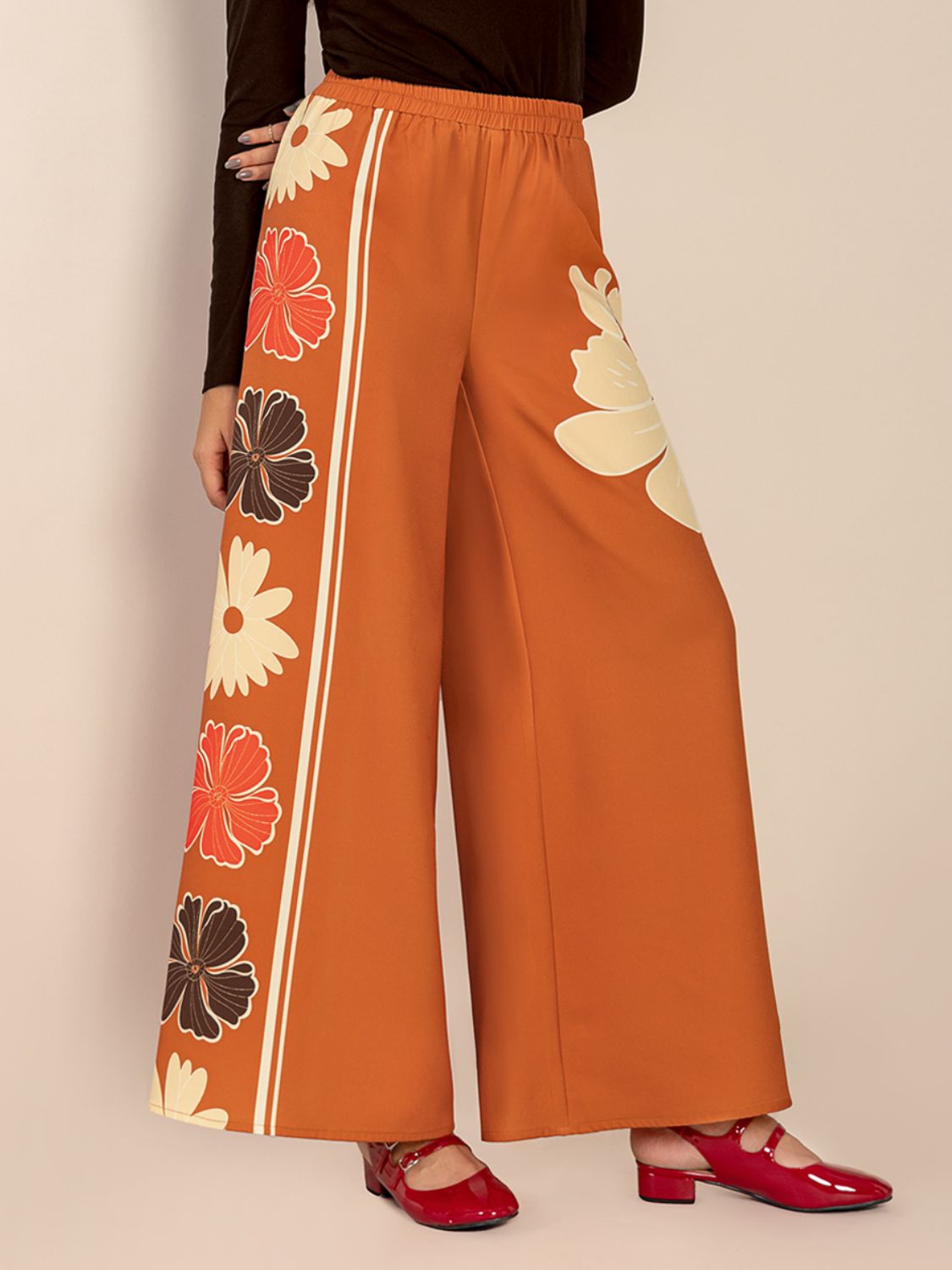 Seventies floral palazzo trousers in tangerine with side stripe detail and wide leg.