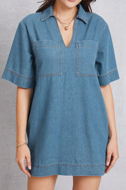 Denim mini dress with plunging collar, short sleeves, and chest pockets in medium wash.