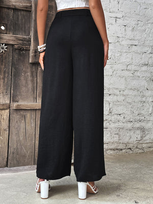 Black belted palazzo trousers with a wide leg and textured fabric.