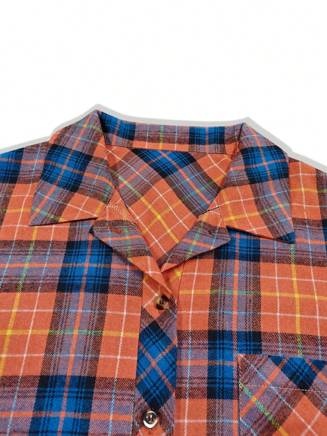 Oversized orange plaid shacket with a relaxed fit, featuring a collar and button front.