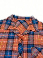 Oversized orange plaid shacket with a relaxed fit, featuring a collar and button front.