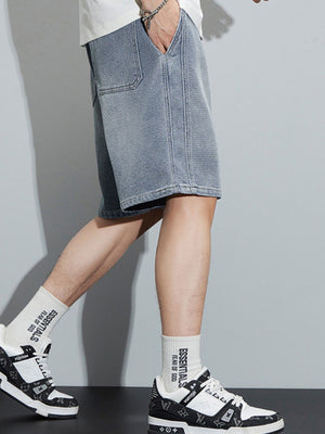 Men's light blue loose fit denim shorts with drawstring waist and pocket detail.