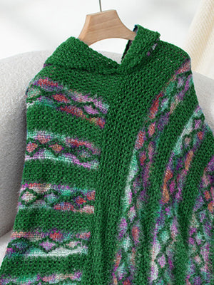 Dark green hooded knit cape with colorful geometric pattern and textured acrylic fabric.