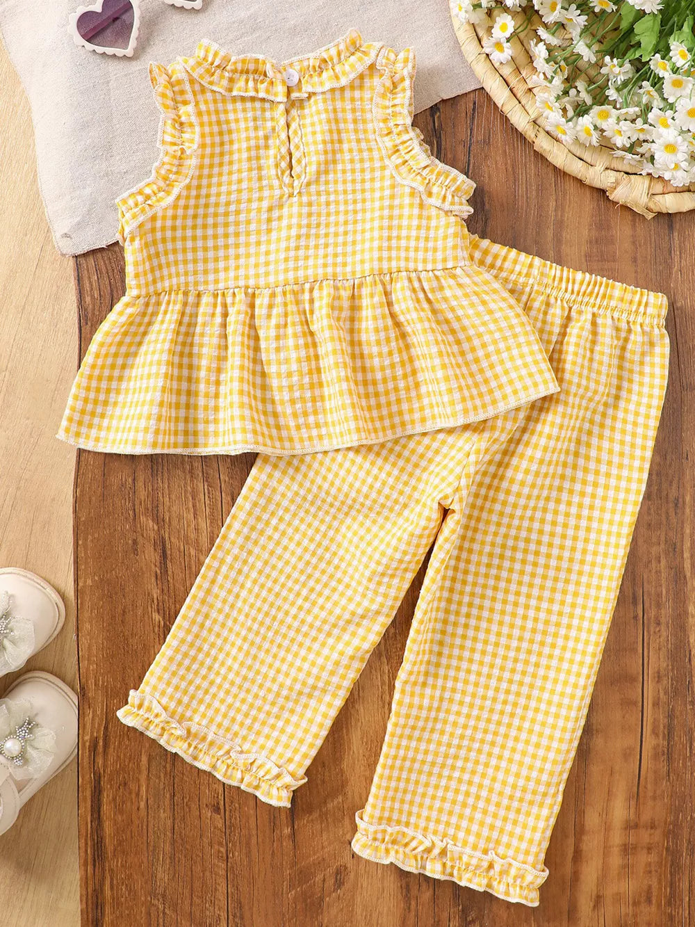 Yellow gingham baby set with ruffled neckline and hem pants.