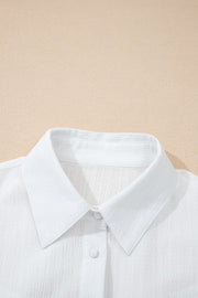 White crinkled texture button-down shirt with classic collar and button detail.