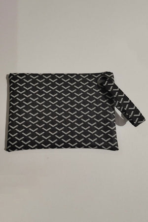 Black clutch bag with geometric pattern and grommet detail wristlet strap