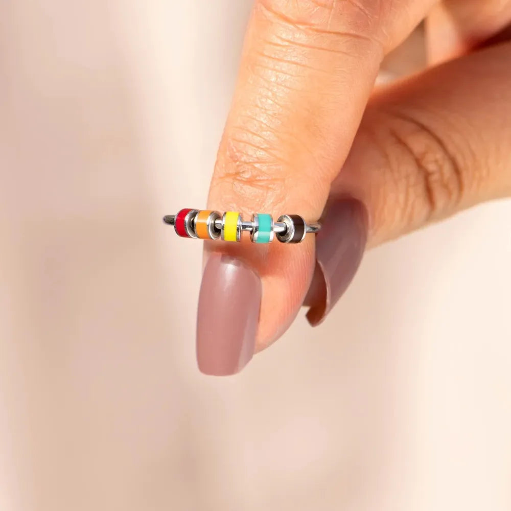 Chromatic bead sterling ring with colorful enamel beads in red, orange, yellow, teal, and black.